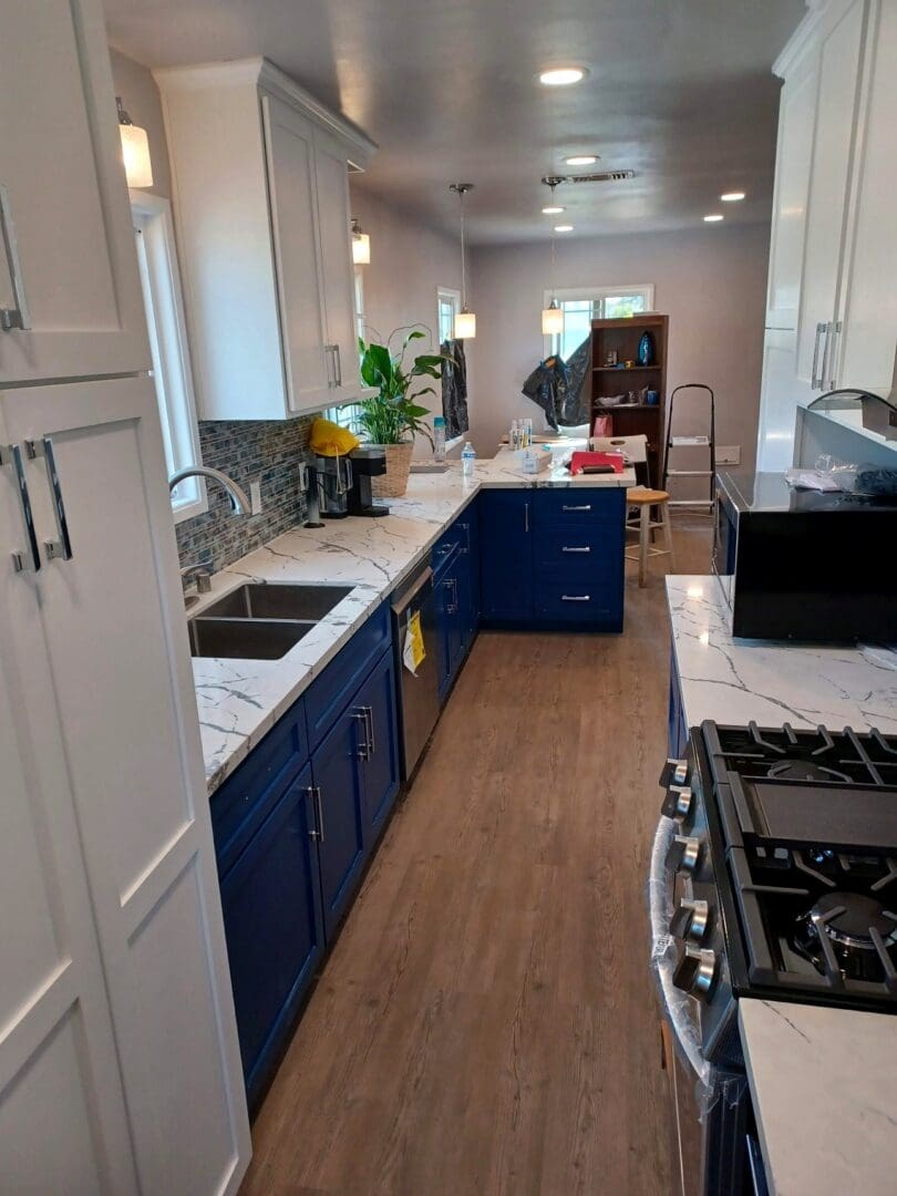 Finished kitchen remodel, galley view with new appliances by Green's Construction, Los Angeles